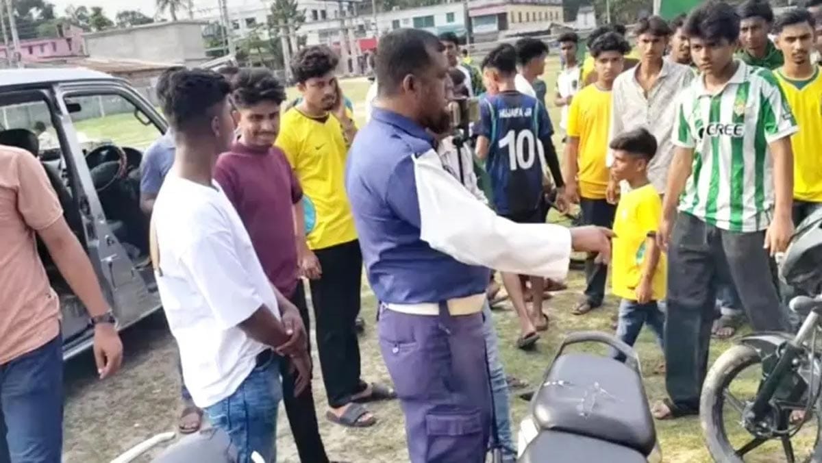 Chuadanga traffic police seizing motorcycles from Brazil football fans during a rally.