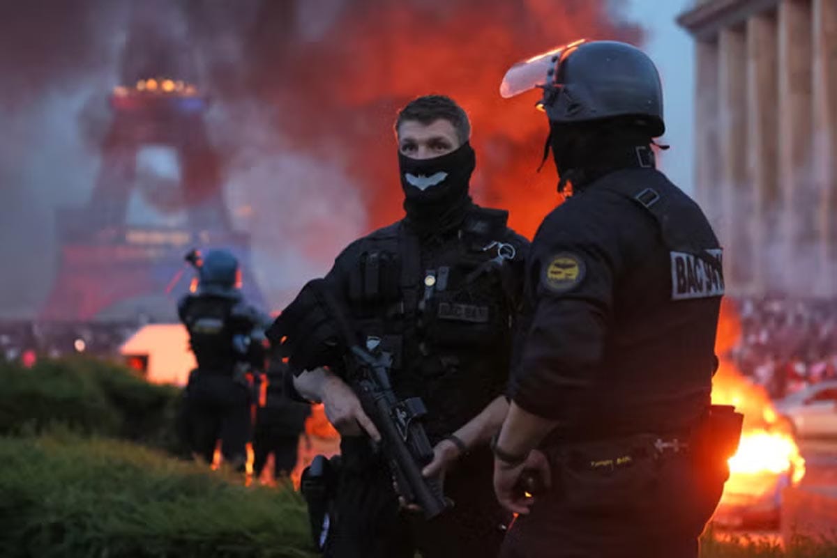 Clashes between French riot police and PSG fans on the Champs-Élysées.