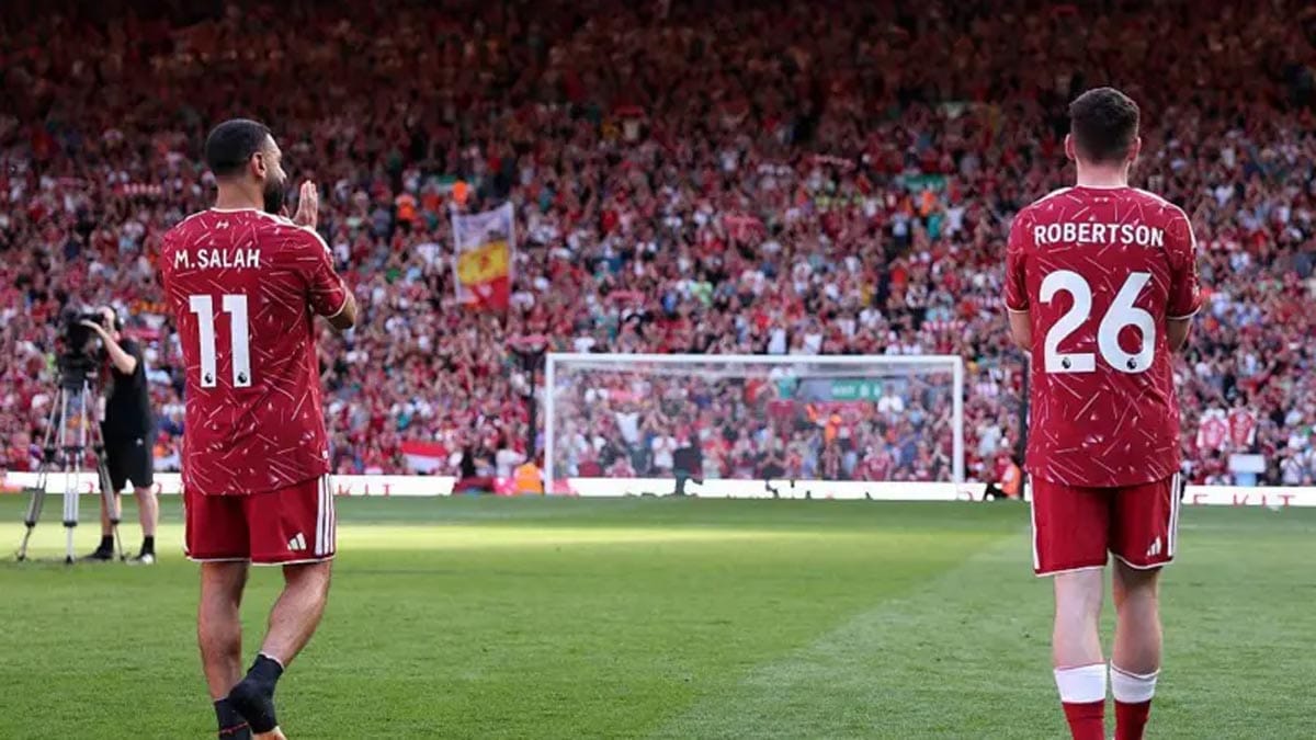 Mohamed Salah and Andy Robertson walking through a guard of honour at Anfield.