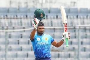 Najmul Hossain Shanto raising his bat after scoring a century in DPL 2026.