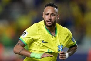 Neymar smiling in Brazil national football team jersey.