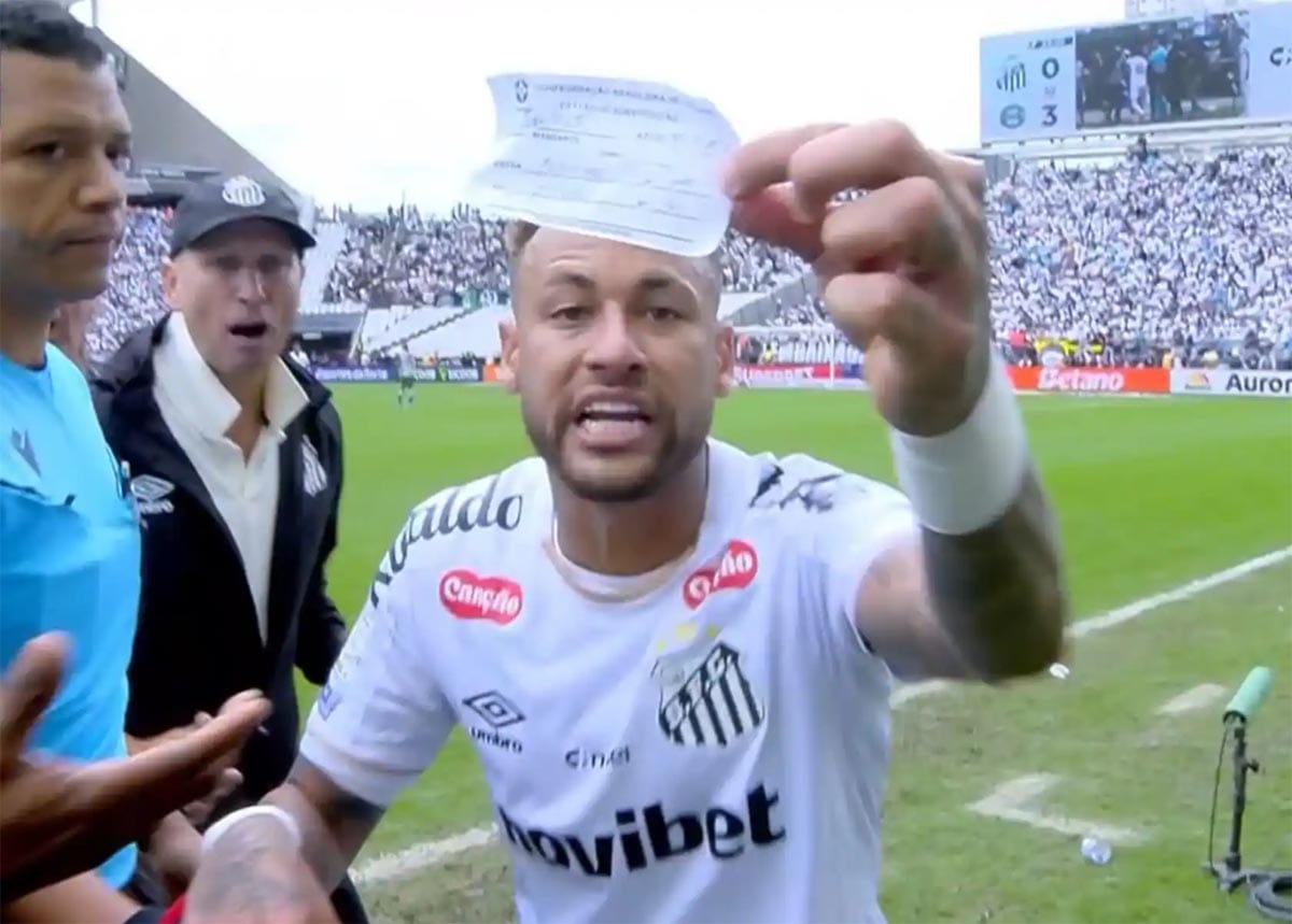 Neymar showing substitution paper to television camera in anger.