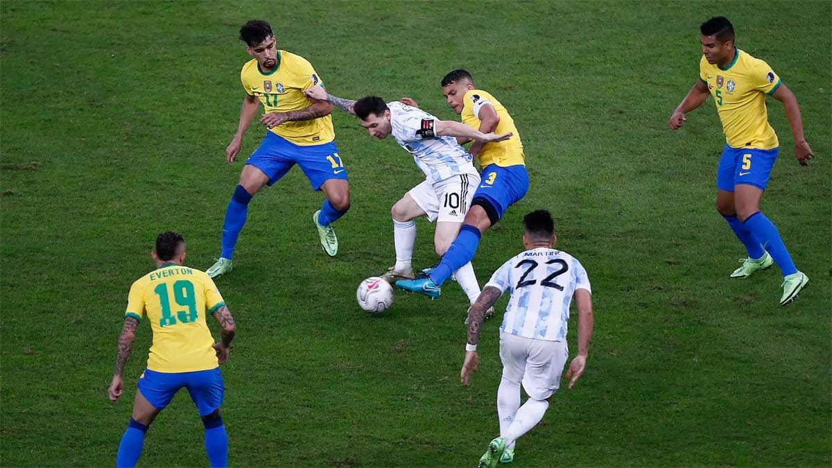 Lionel Messi trying to dribble in a friendly match between Brazil and Argentina.