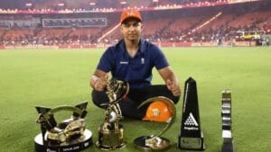 15-year-old Vaibhav Sooryavanshi posing with the IPL 2026 Orange Cap and trophies.