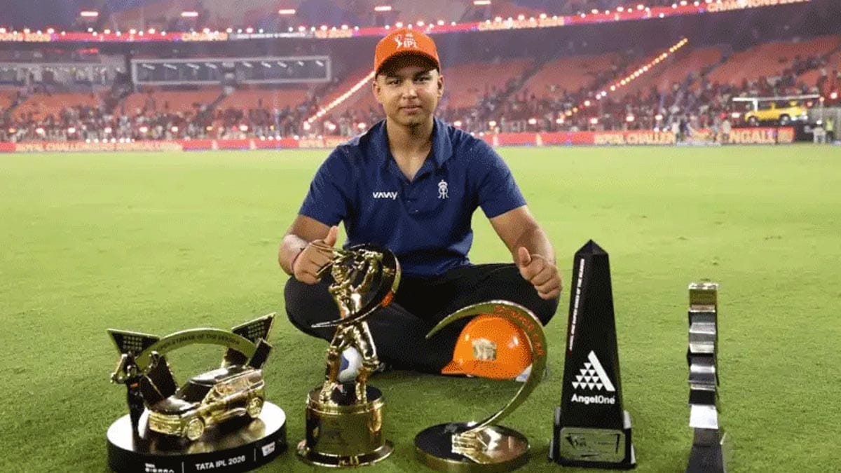15-year-old Vaibhav Sooryavanshi posing with the IPL 2026 Orange Cap and trophies.